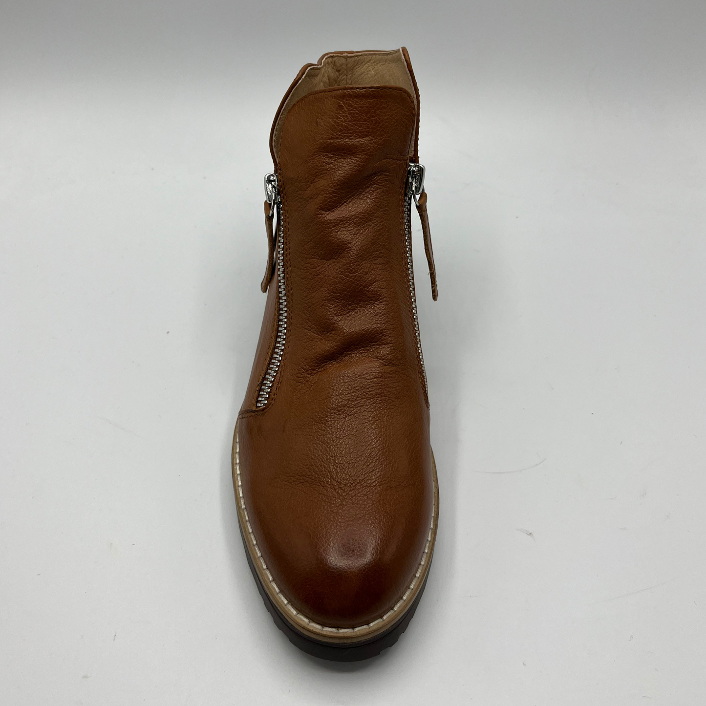 Brown leather boot with a double zipper on a white background