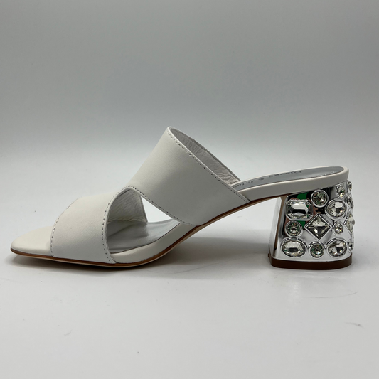 Left facing view of a white leather sandal with a 1/4" bejewelled heel and side cut outs.