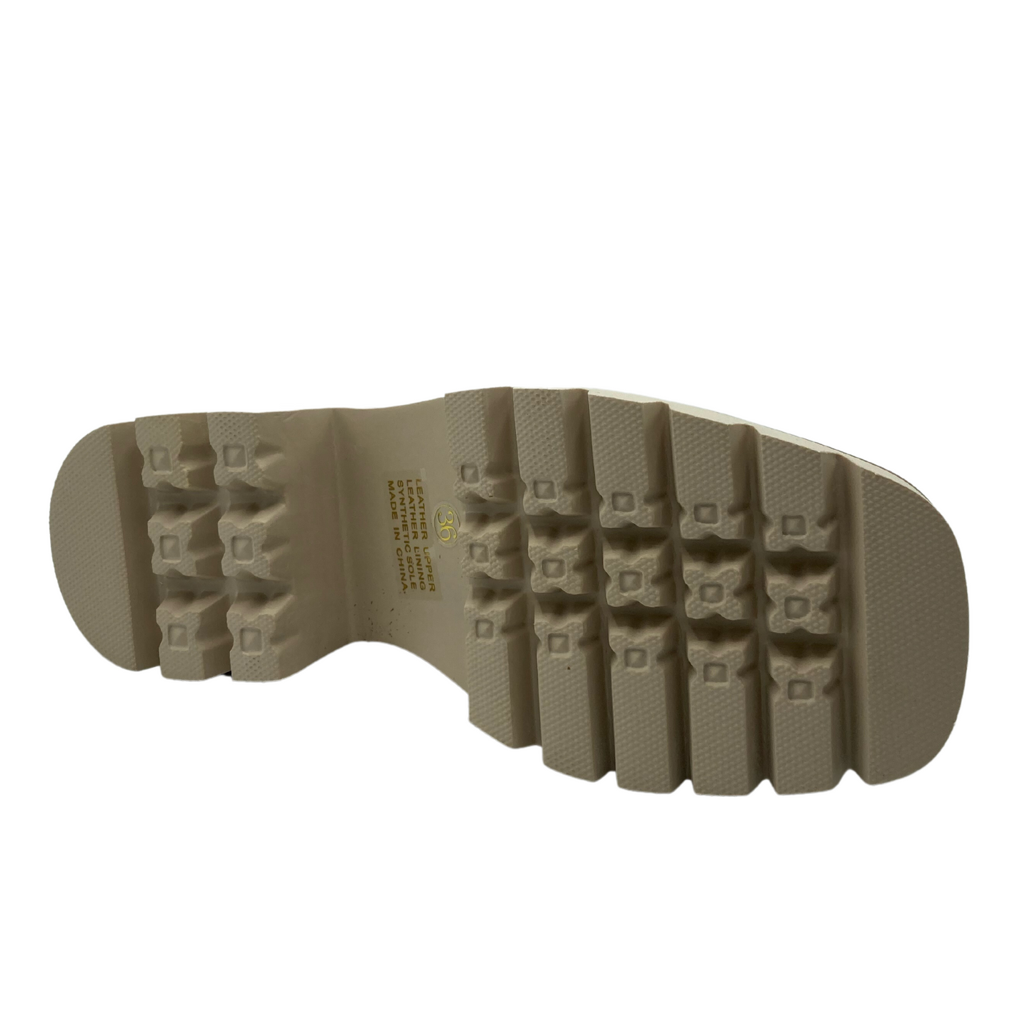 Bottom view of vanilla coloured rubber sole of leather loafer