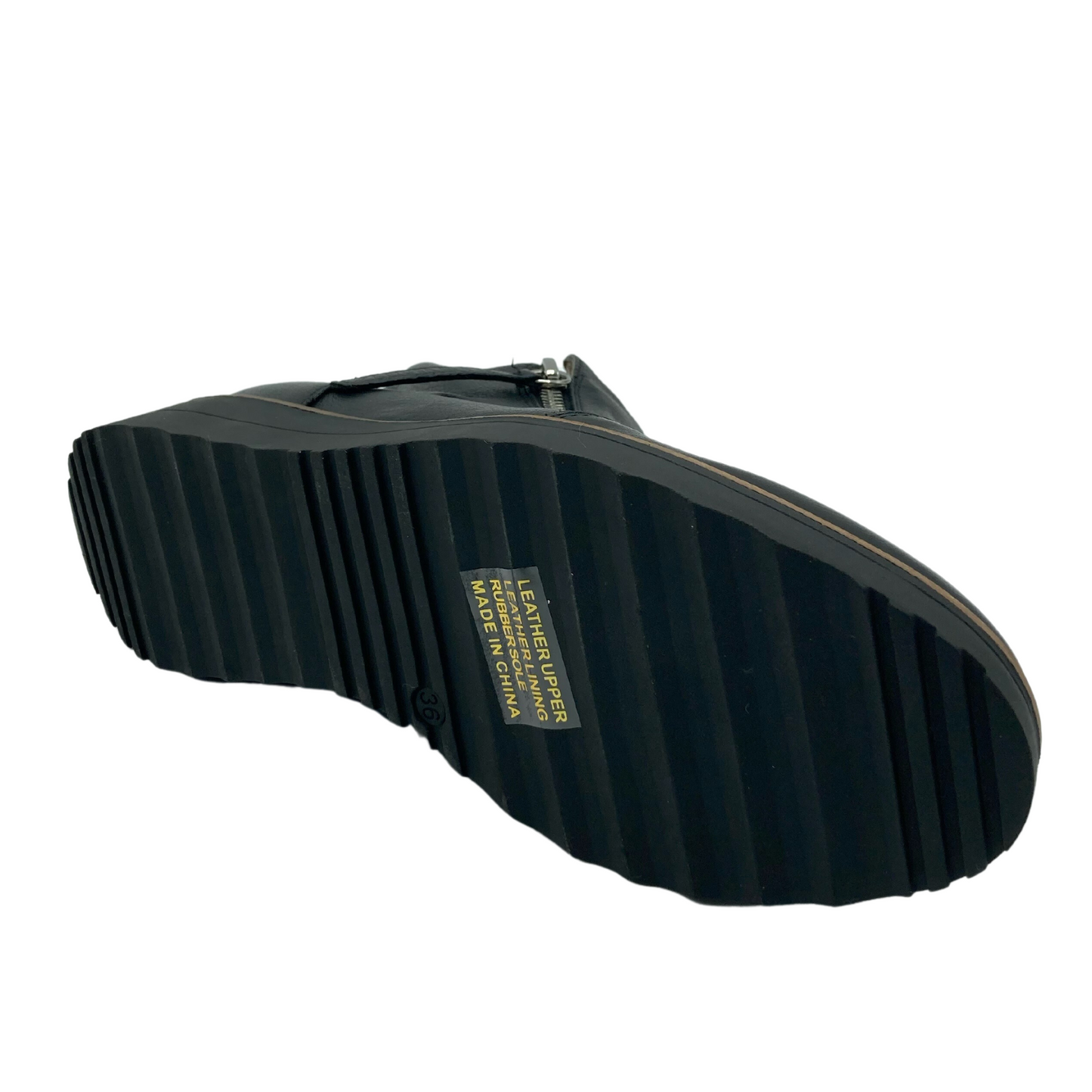 Bottom view of a short leather boot with black rubber sole