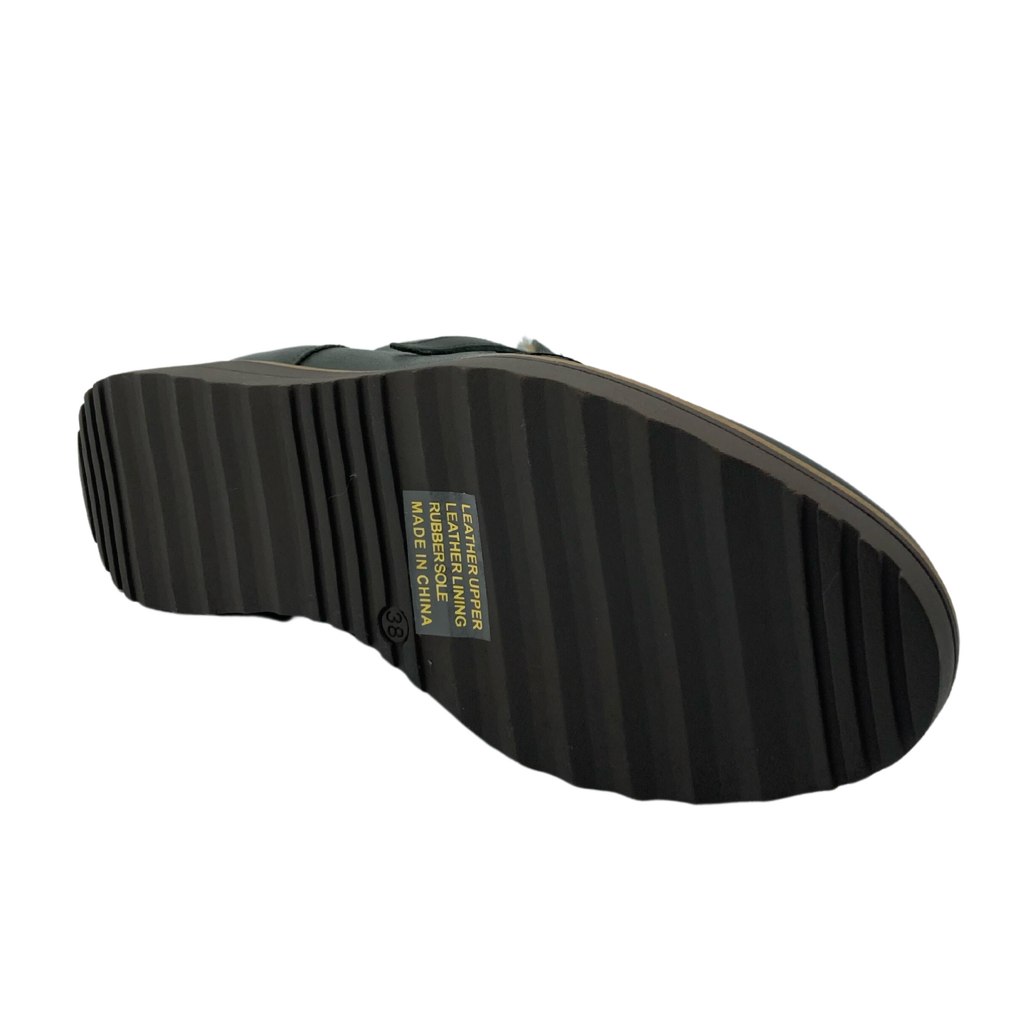 Bottom view of a shoe laying on its side with a dark brown rubber sole