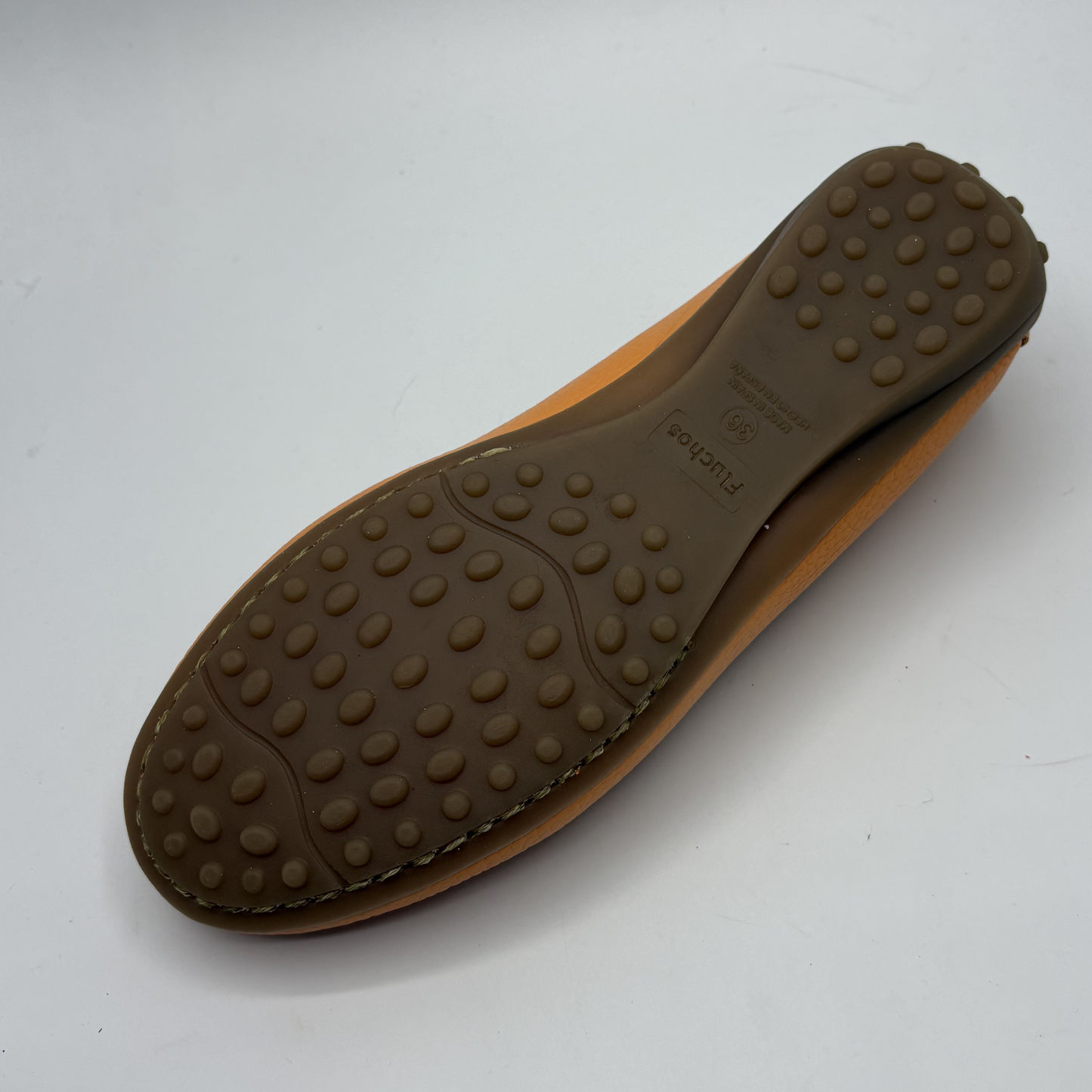 Brown shoe sole with textured surface on a white background