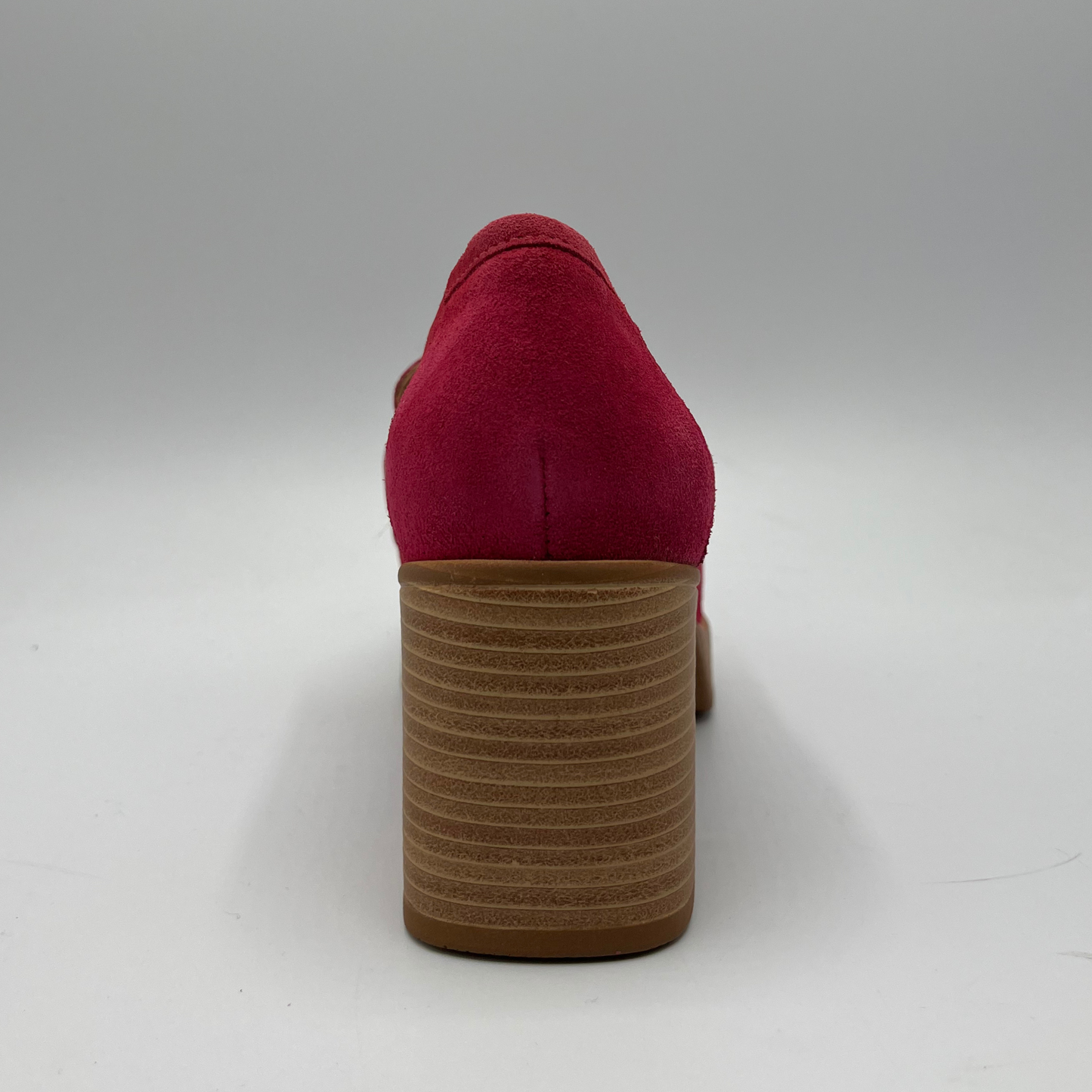 Back view of a suede fuchsia high heeled loafer with a stacked heel and platform. Featuring gold and fuschia coloured detail.