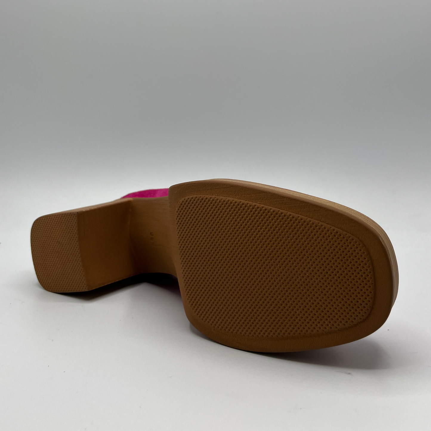 Bottom view of a suede fuchsia high heeled loafer with a stacked heel and platform. Featuring gold and fuschia coloured detail.
