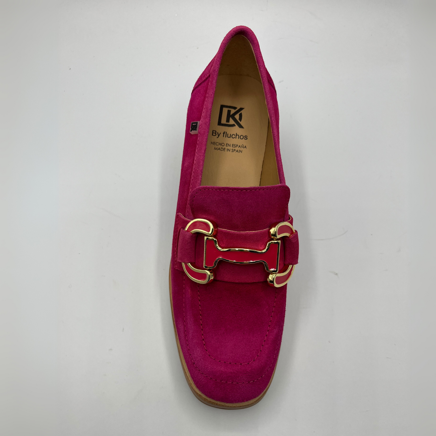 Top view of a suede fuchsia high heeled loafer with a stacked heel and platform. Featuring gold and fuschia coloured detail.