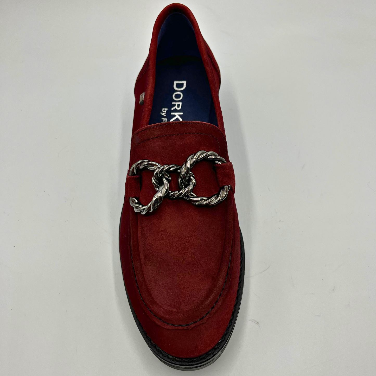 Red loafer shoe with a silver chain detail on a white background