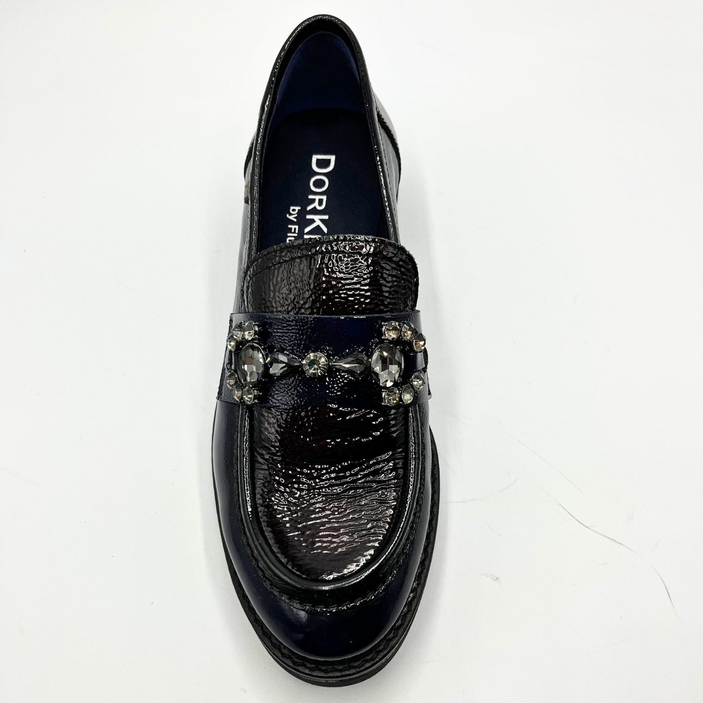Navy loafer shoe with decorative elements on a white background