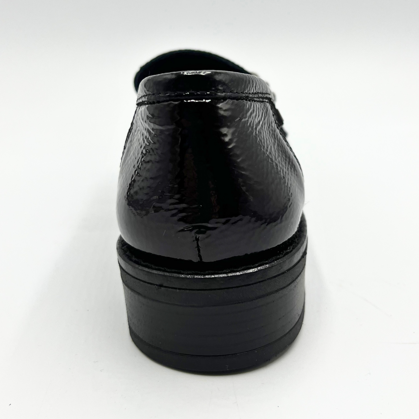 Navy patent leather dress shoe on a white background
