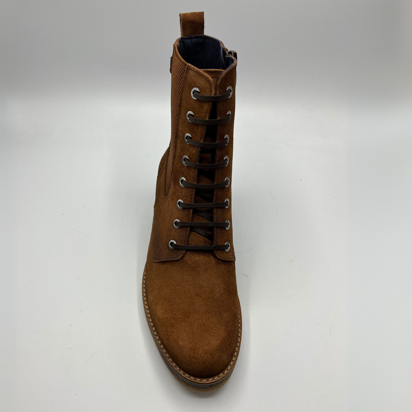 Brown suede boot on a white background