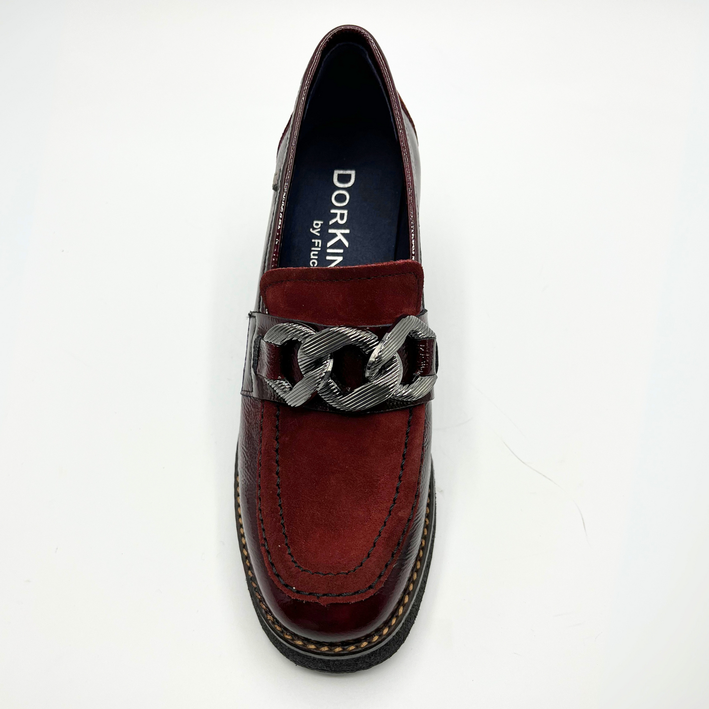 Red loafer shoe with chain detail on a white background