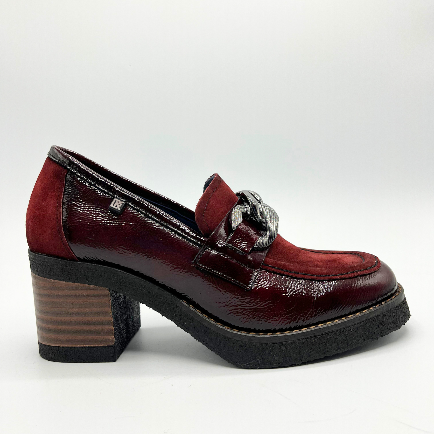 Red leather shoe with a block heel on a white background