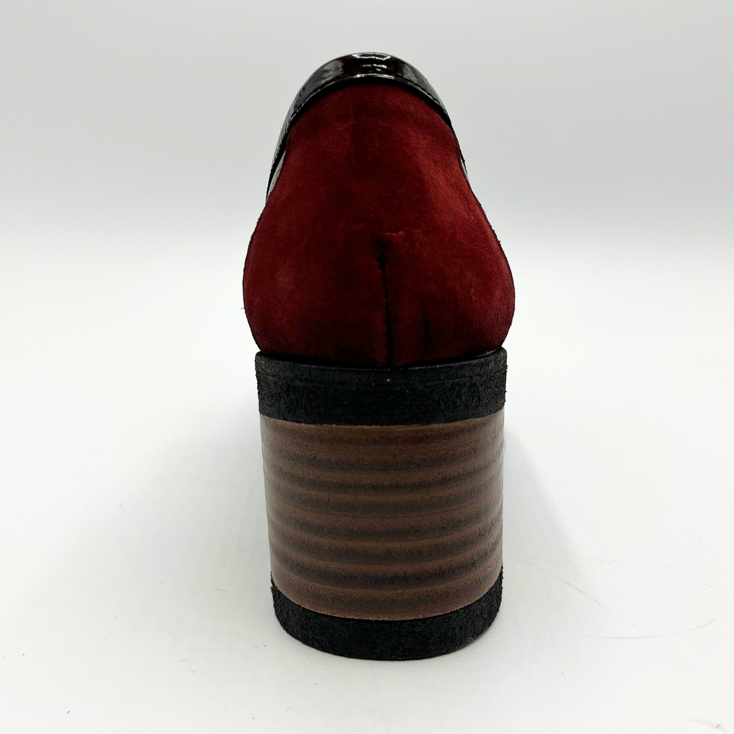 Red shoe with a brown sole on a white background
