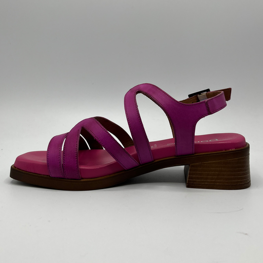 Left facing view of a fucsia coloured sandal with an adjustable slingback strap, stacked heel and cushioned insole.