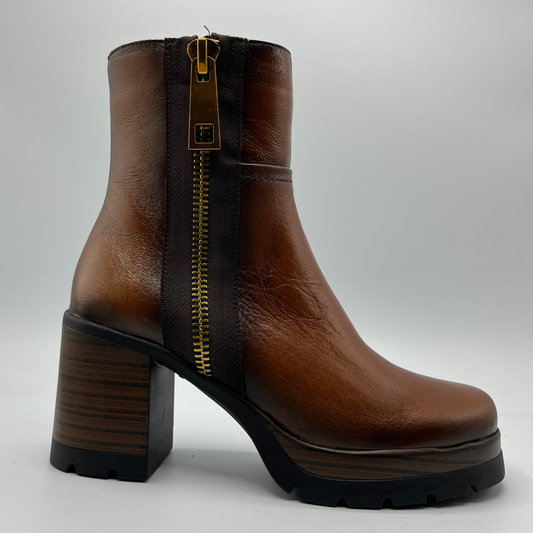 Brown leather boot with a gold zipper on a white background