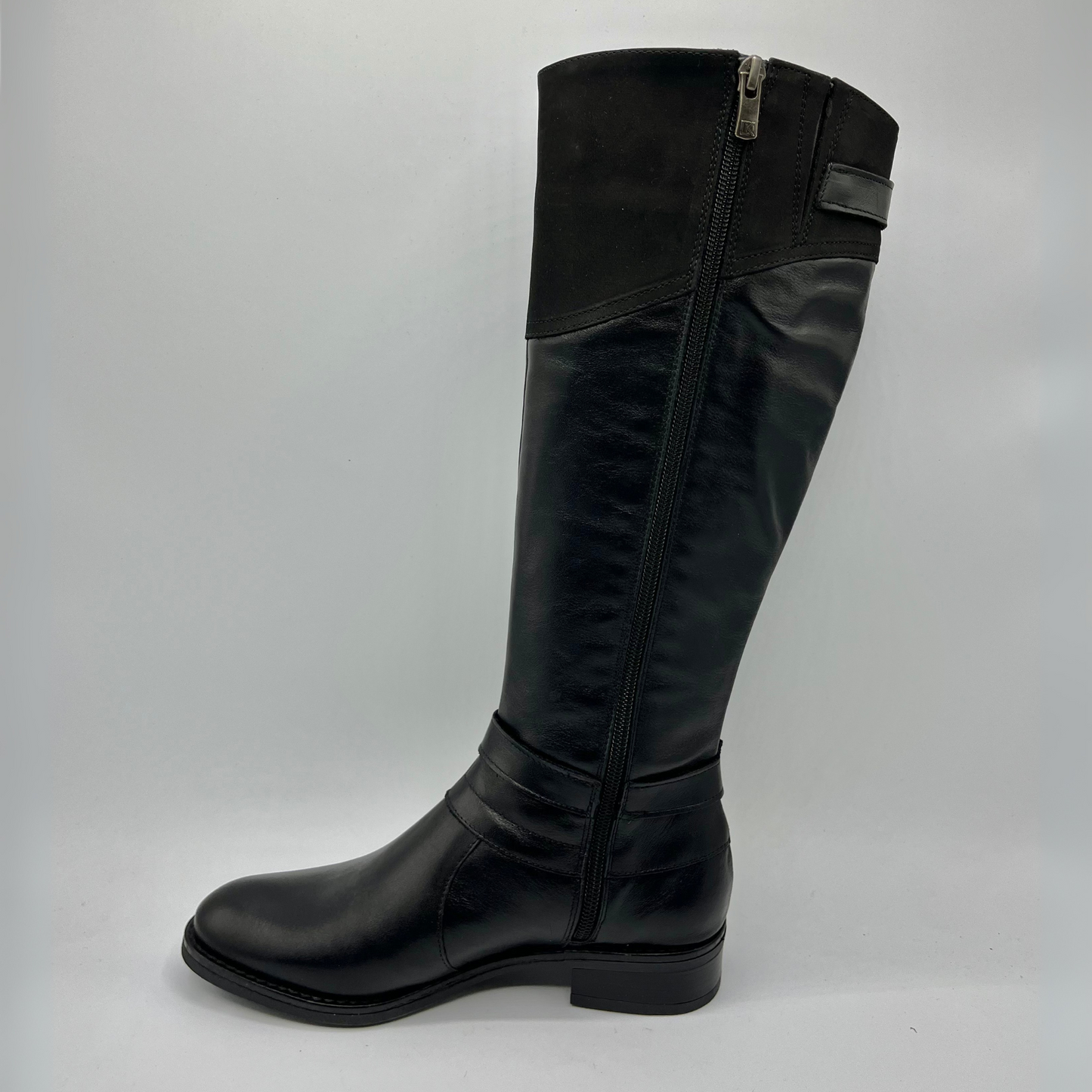 Black knee-high boot on a gray background