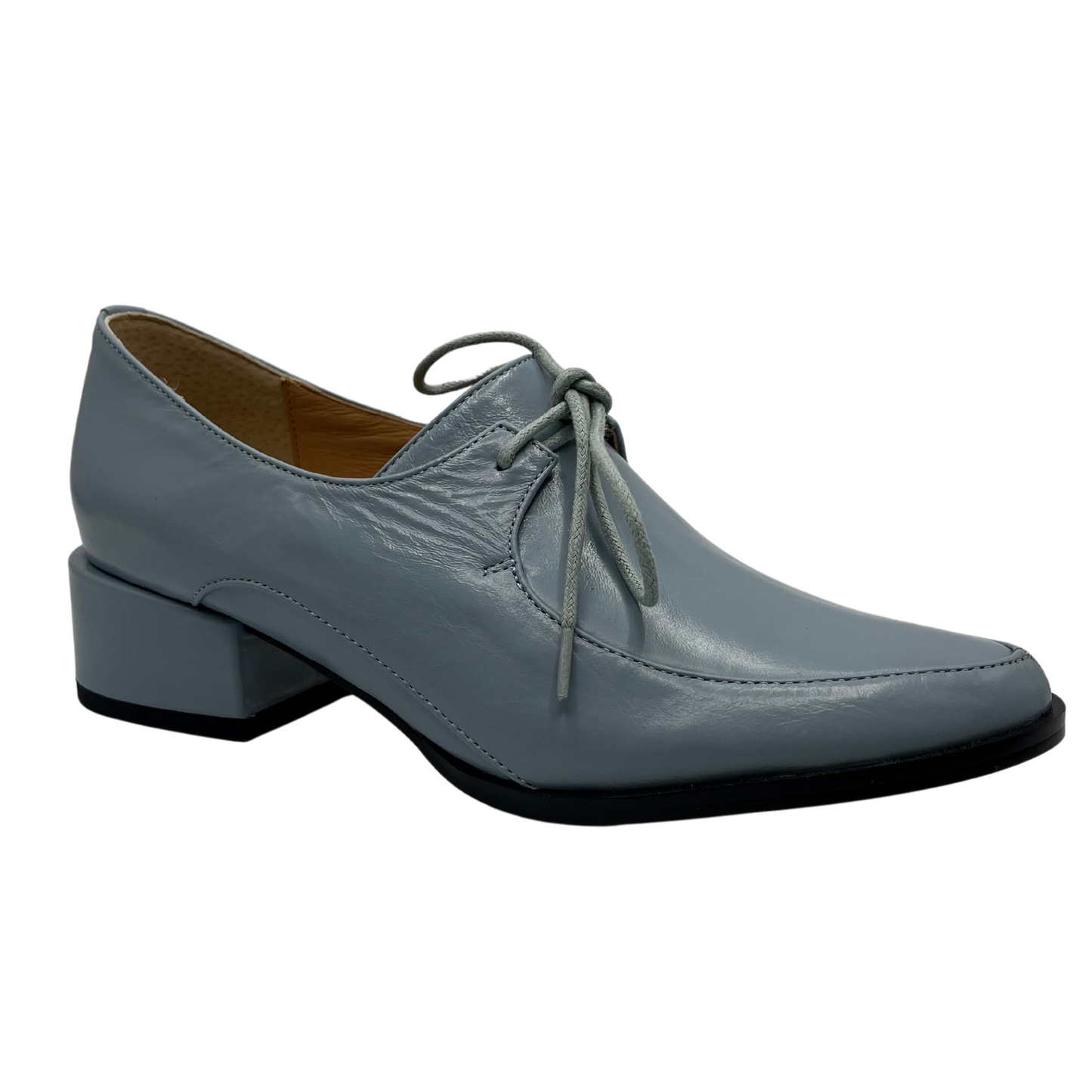 45 degree angled view of a blue leather derby shoe with leather lining, wrapped block heel and ingle eyelet laces.