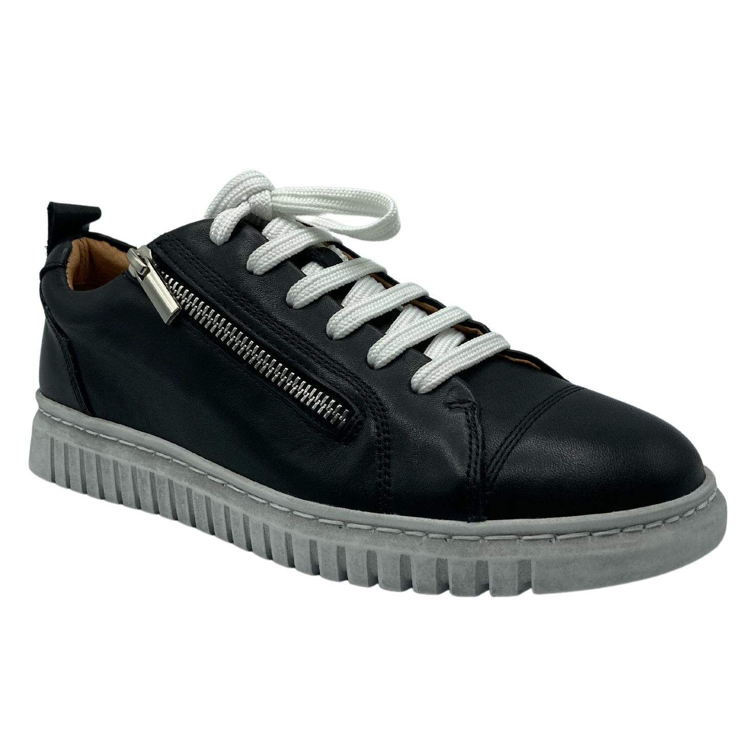 45 degree angled view of black leather sneaker with white laces and white rubber outsole