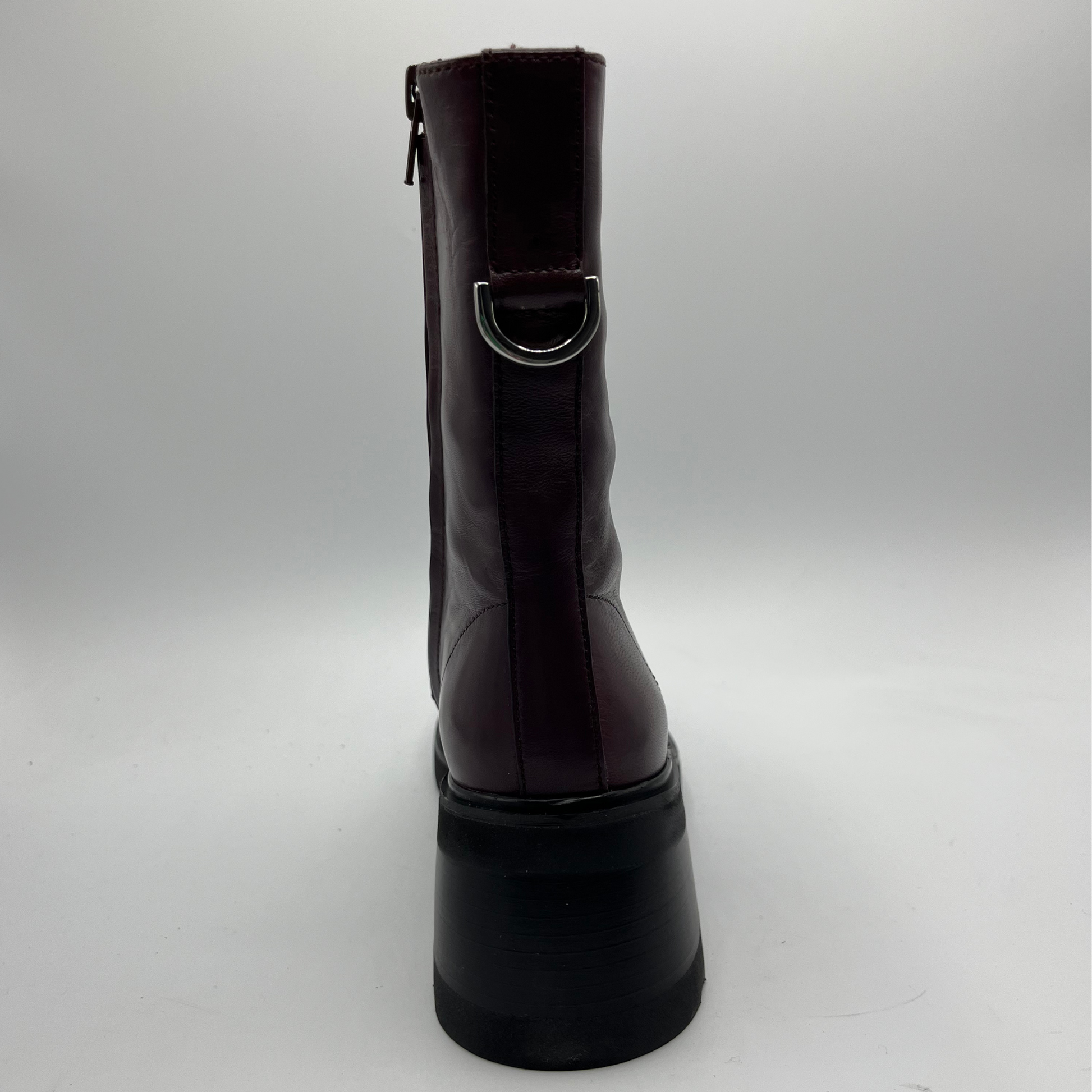 Maroon boot with a buckle on a white background