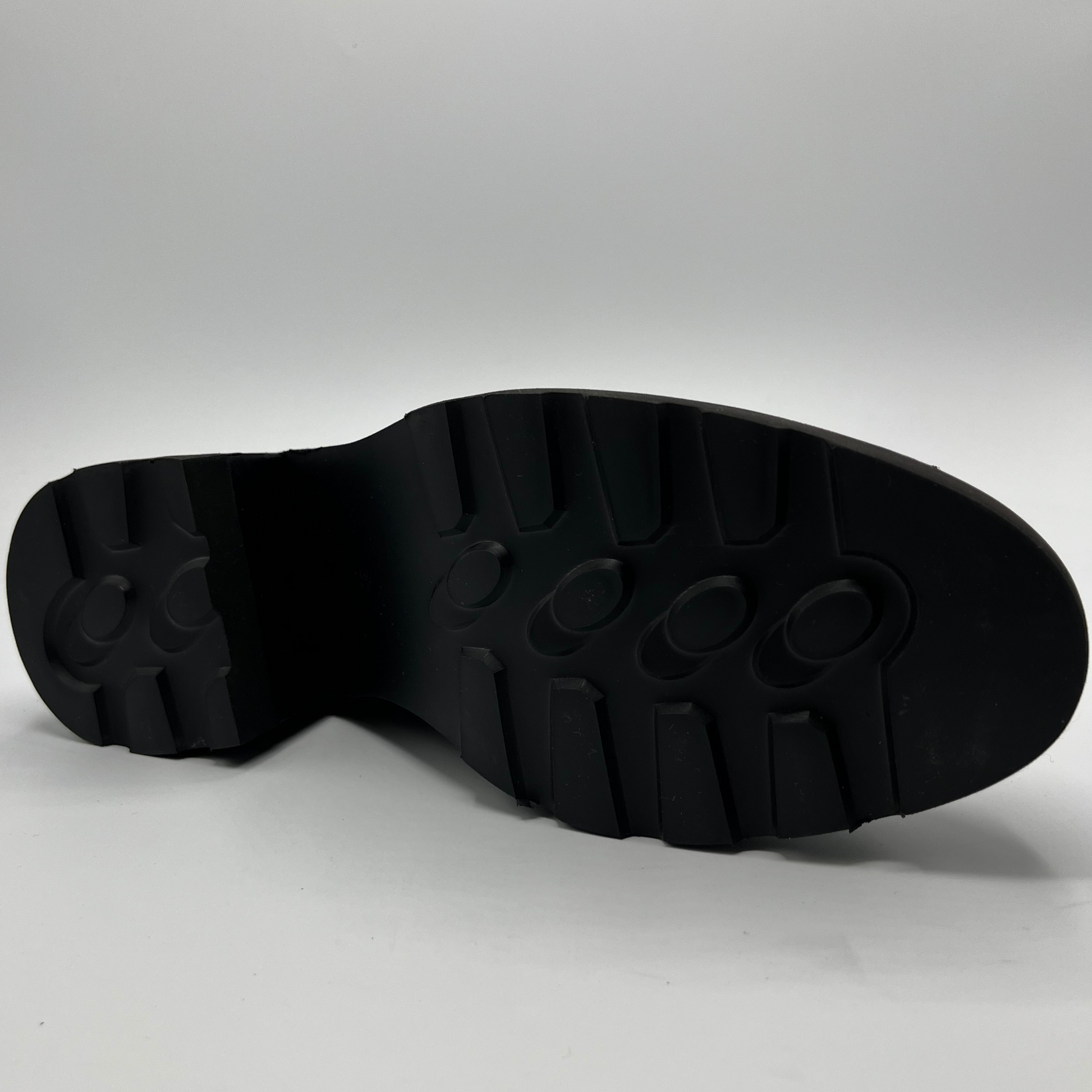Black sole of a shoe on a gray background