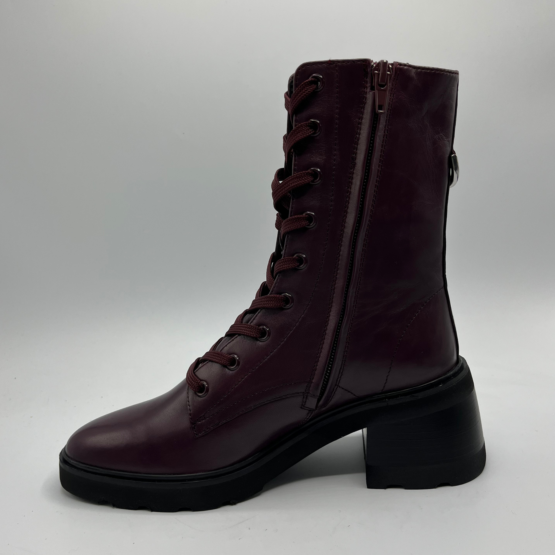 Dark brown leather boot with laces on a light gray background