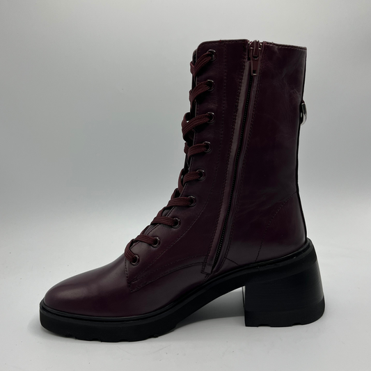Dark brown leather boot with laces on a light gray background