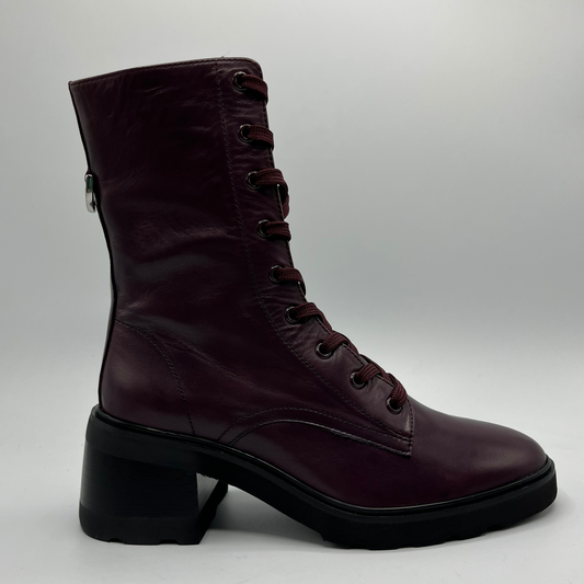 Maroon boot with a block heel on a light gray background