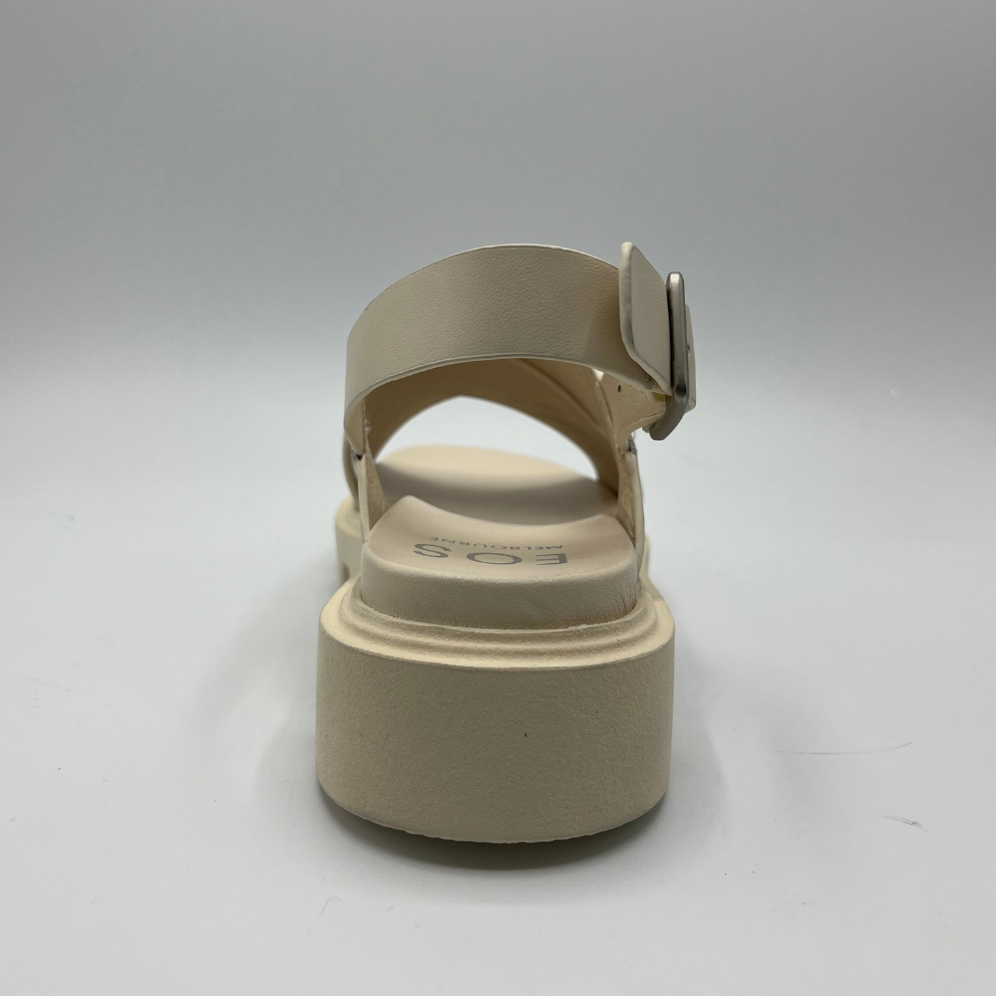 Back view of a bone coloured chunky sandal with an adjustable slingback strap and cross over strapped upper.