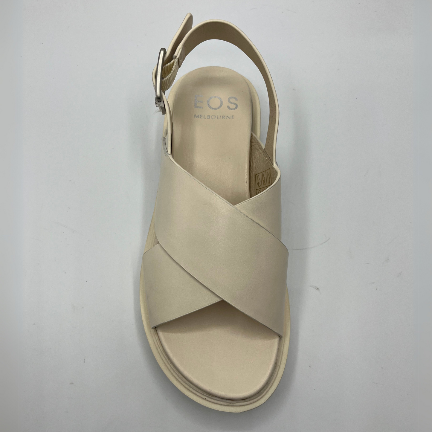 Top view of a bone coloured chunky sandal with an adjustable slingback strap and cross over strapped upper.