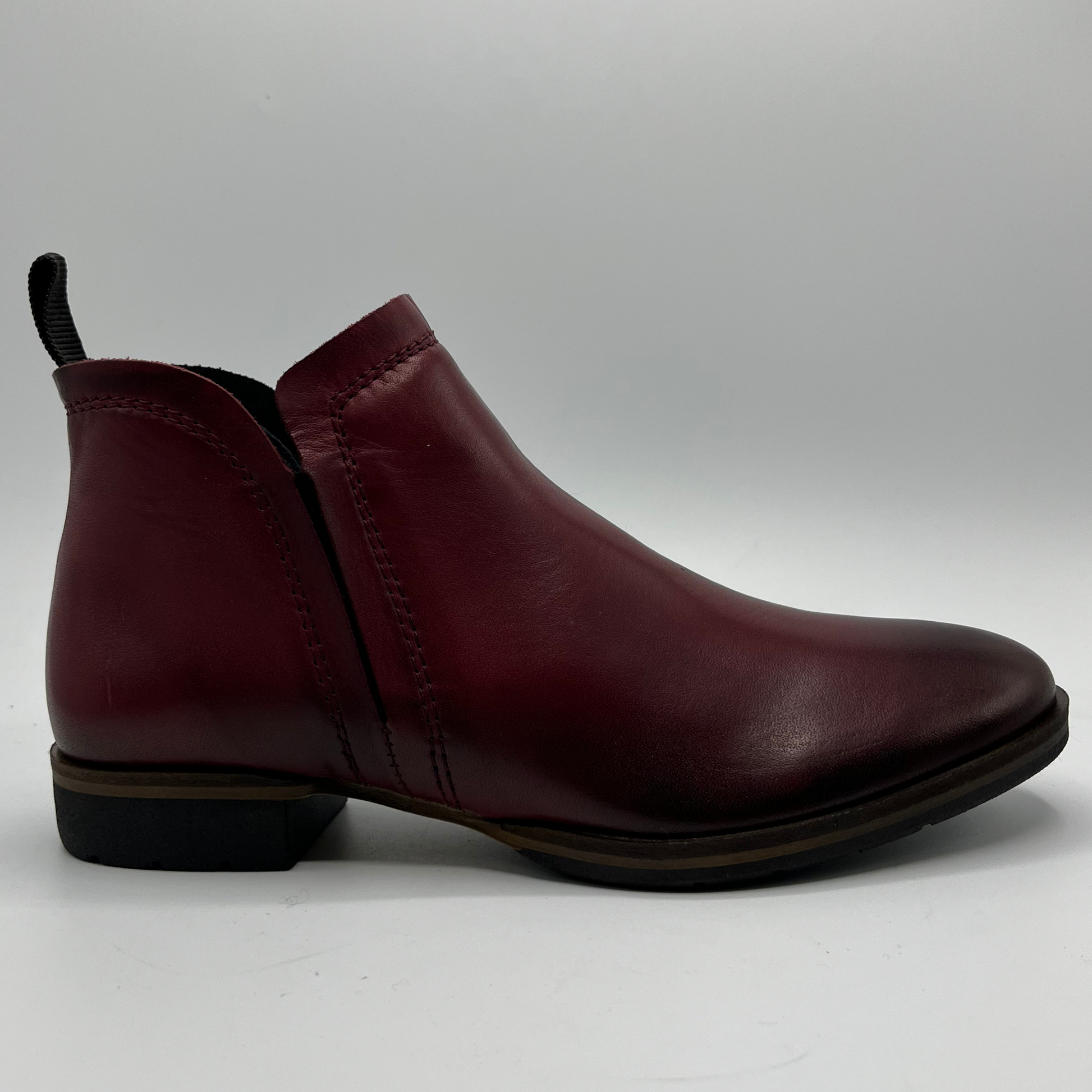Maroon leather ankle boot on a white background