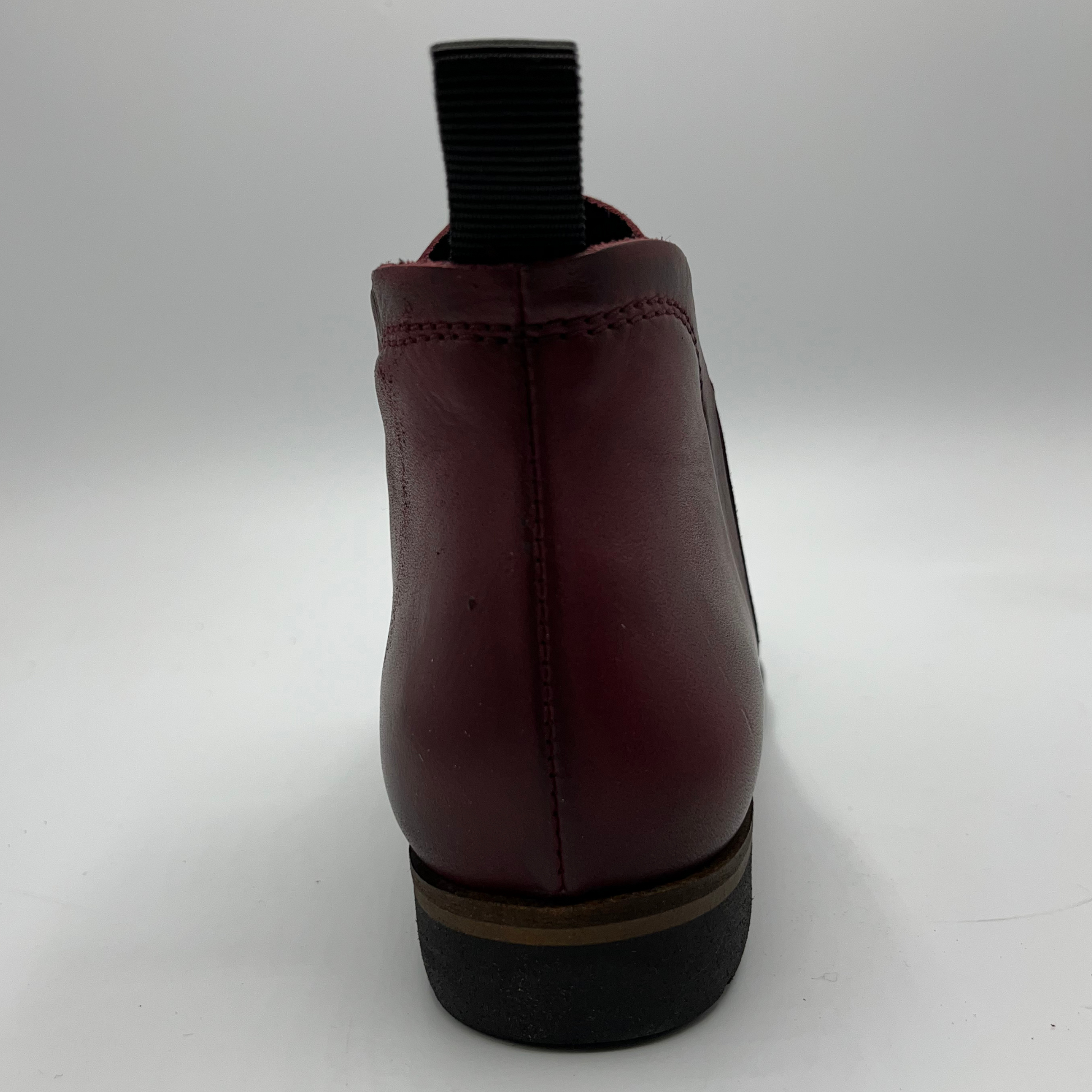Maroon ankle boot on a white background