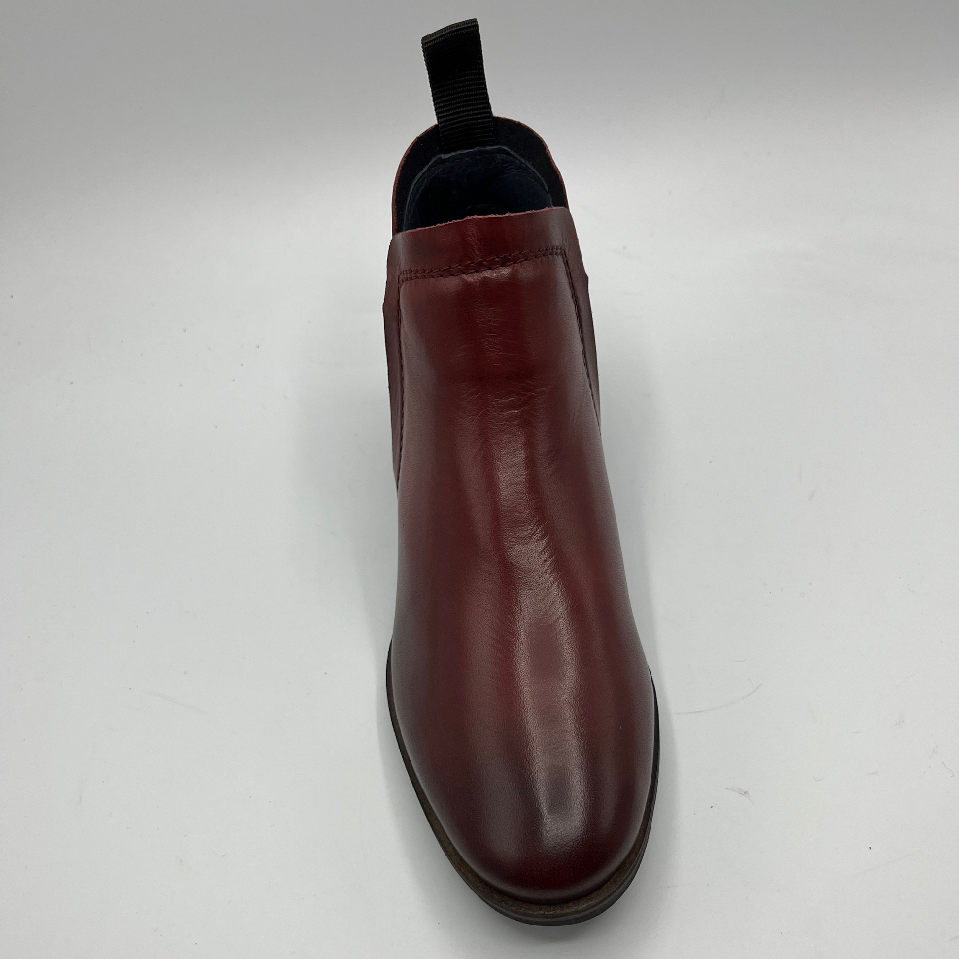 Brown leather boot on a white background