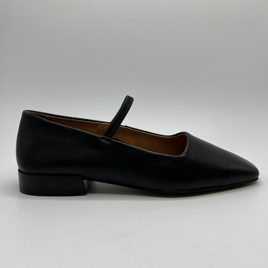 Black leather flat shoe with a strap on a white background
