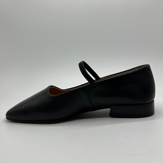 Black leather flat shoe on a light gray background