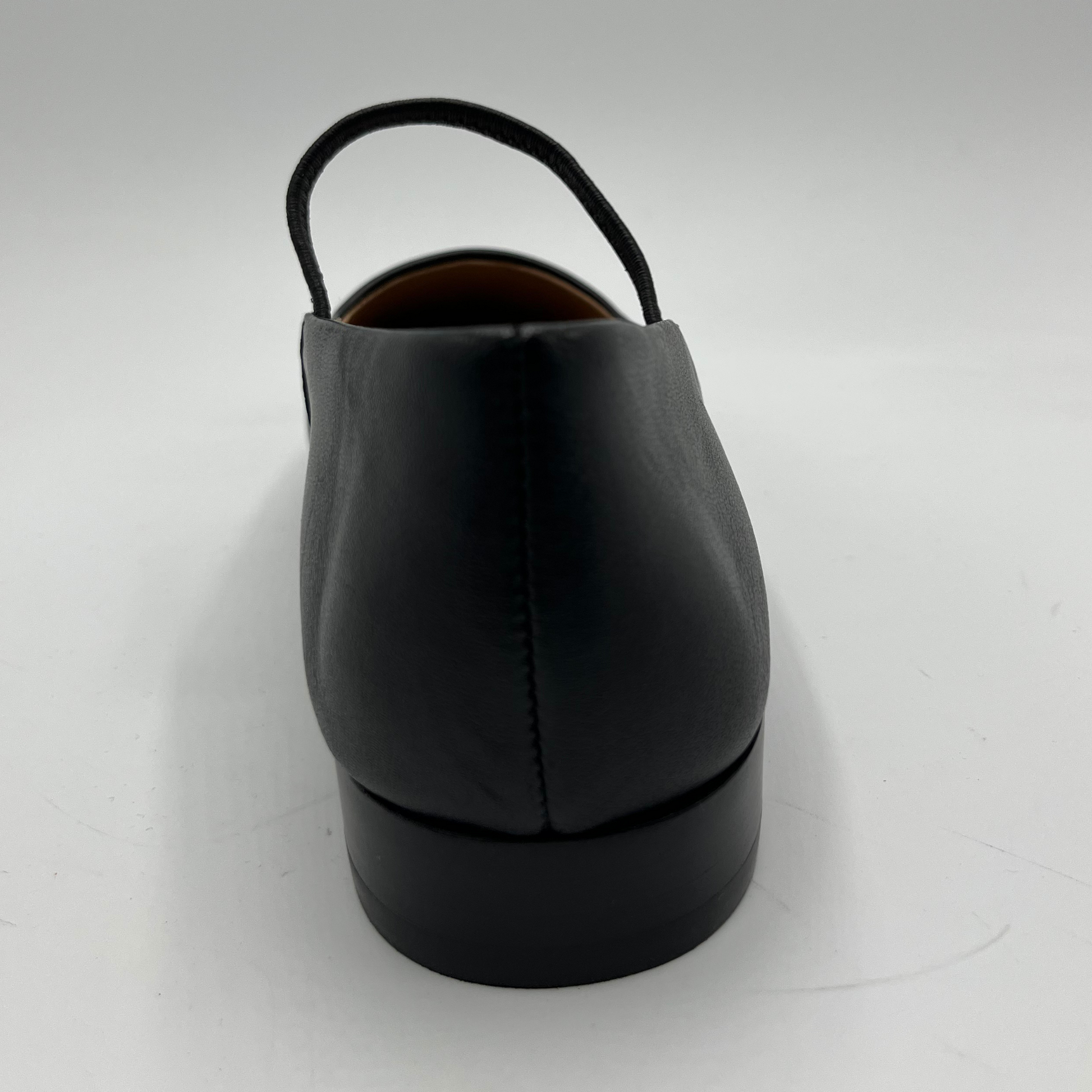 Black leather shoe on a white background