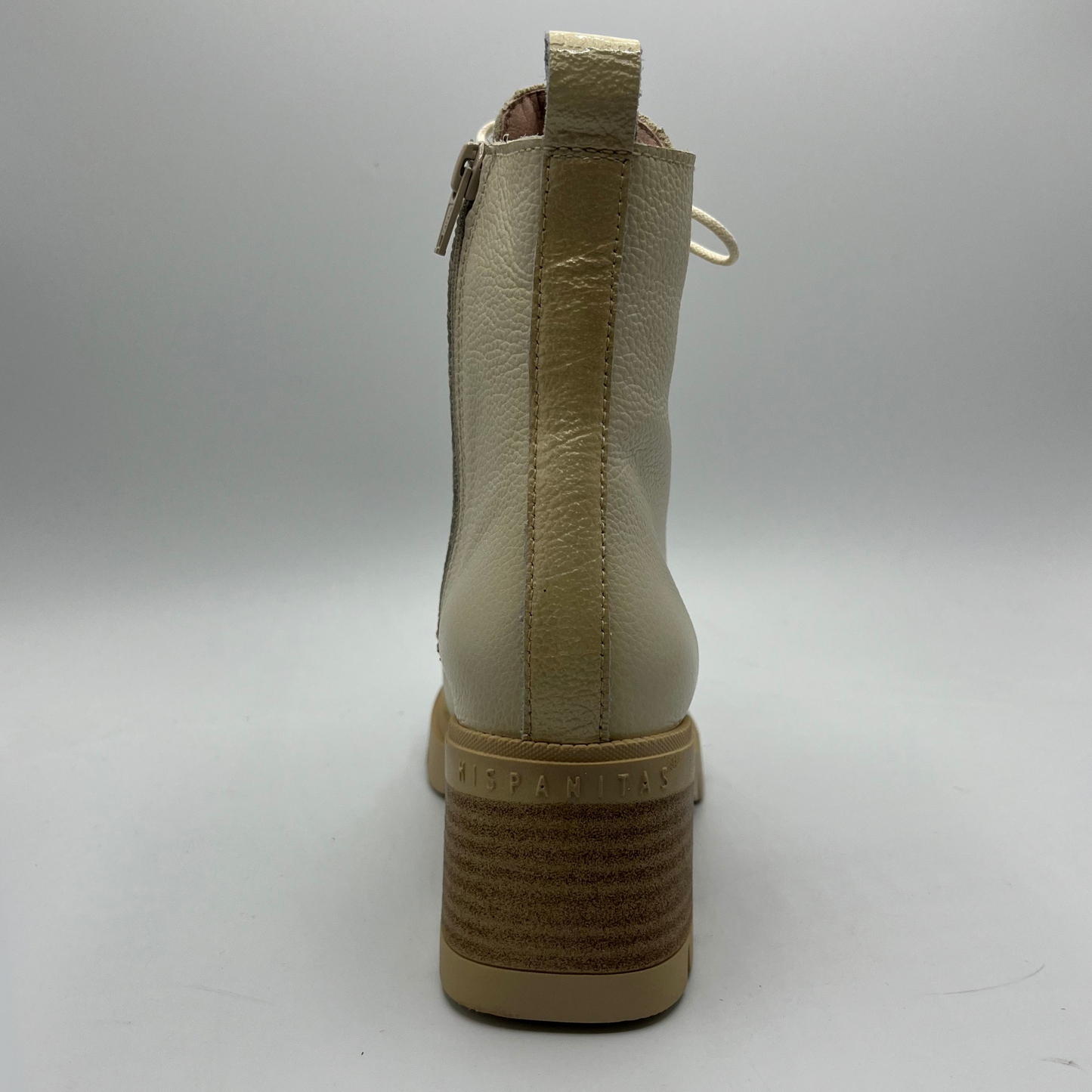 Beige ankle boot on a gray background