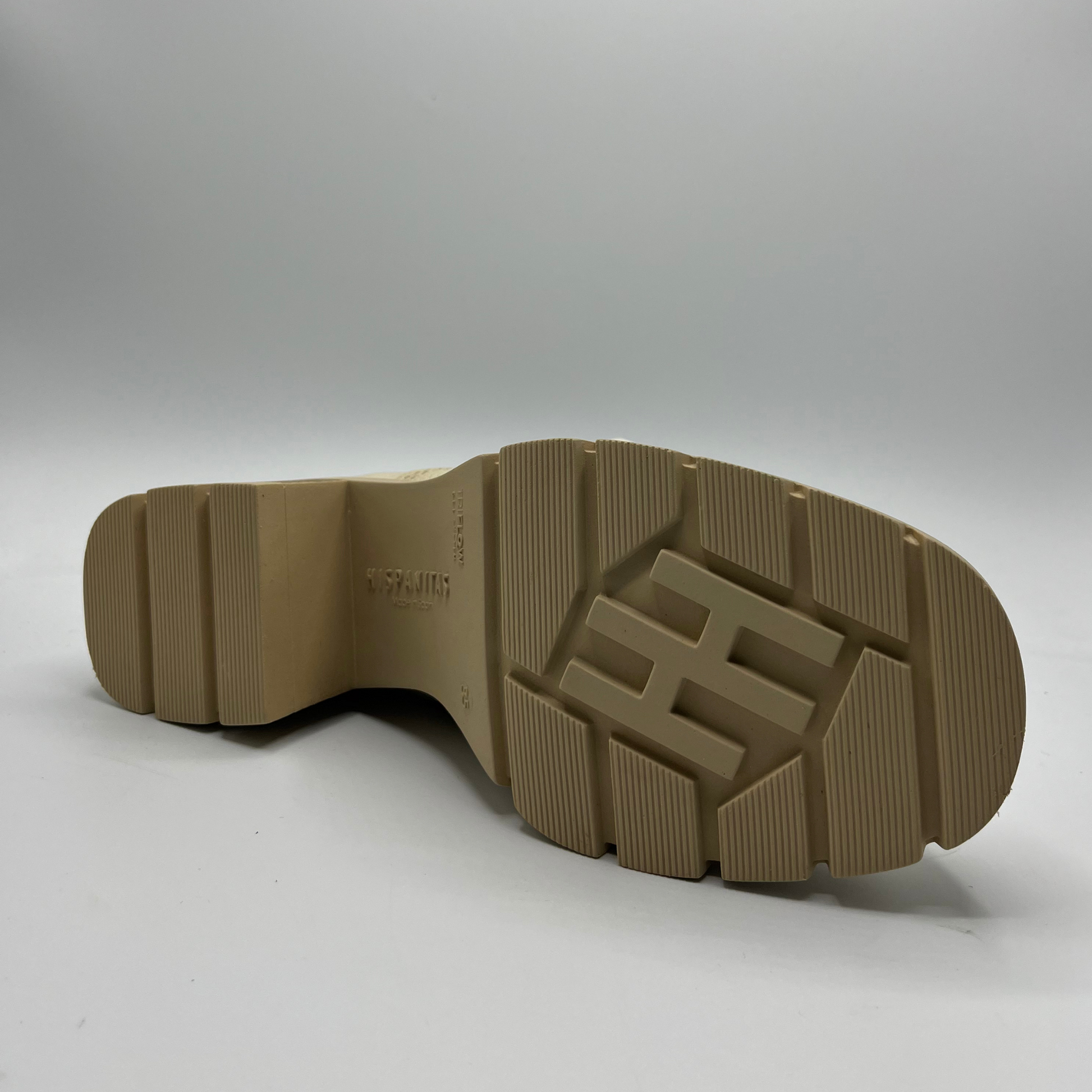 Brown sole of a shoe with a brand logo on a white background