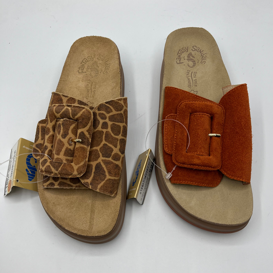 Top view of two slip on sandals with contoured footbed. One has a giraffe print strap and buckle and the other is a burnt orange strap and buckle.
