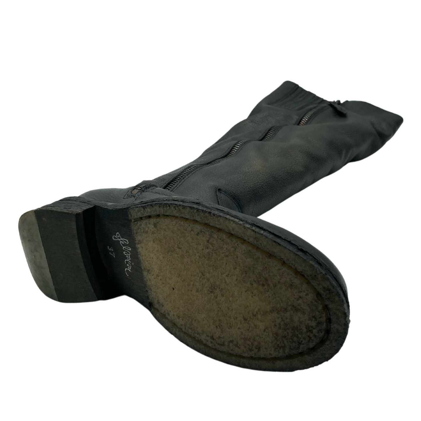 View of the bottom of a tall, grey, leather boot with zipper closure