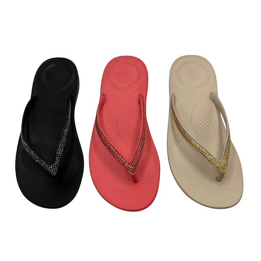 Top down view of three sandals in a row. Left is black, middle is coral and the right is beige. All have a bejewelled thong strap.