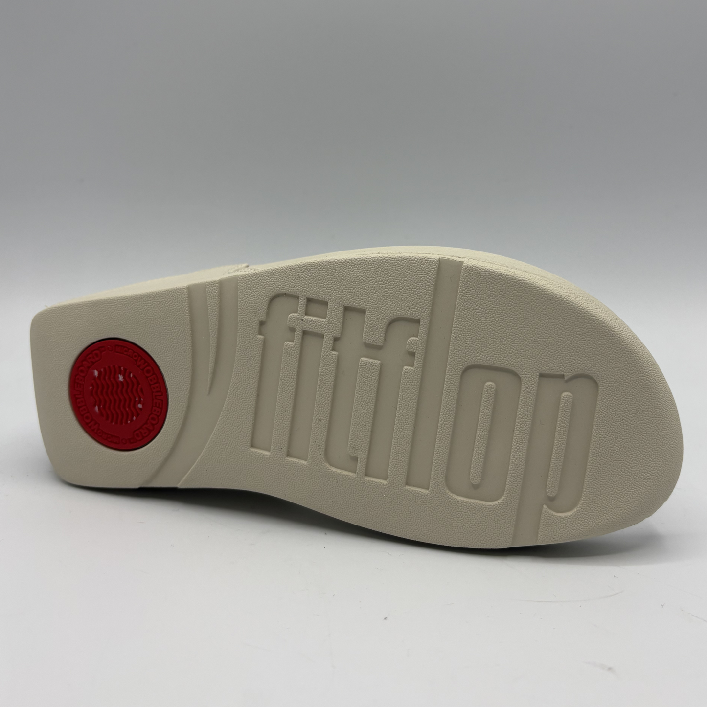 Beige shoe sole with 'fitflop' branding on a white background