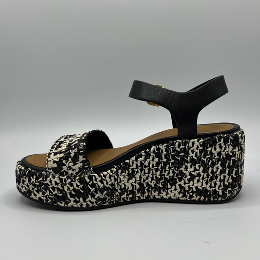 Left facing view of a two-toned woven platform wedge with a black leather ankle strap and gold buckle.