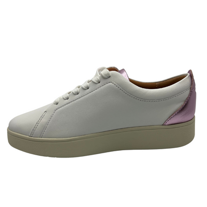 Left facing view of white leather sneakers with white laces, rubber outsole and metallic lilac detail on heel