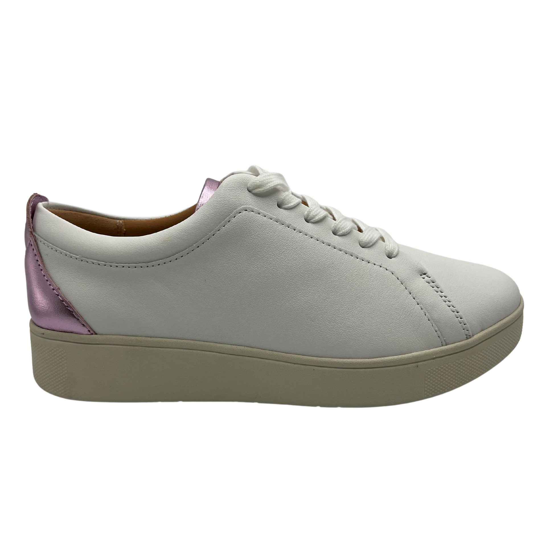 Right facing view of white leather sneakers with white laces, rubber outsole and metallic lilac detail on heel