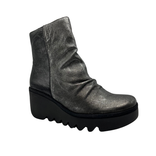 45 degree angled view of dark silver leather bootie with wedge heel and side zipper closure