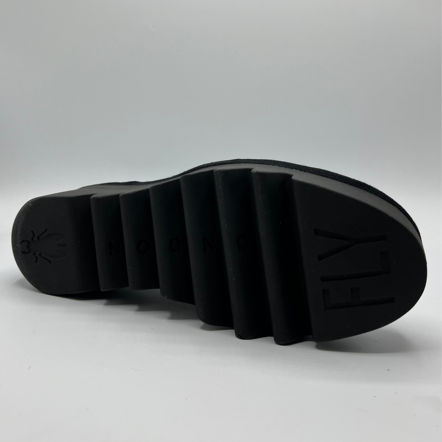 Black sole of a shoe on a light gray background
