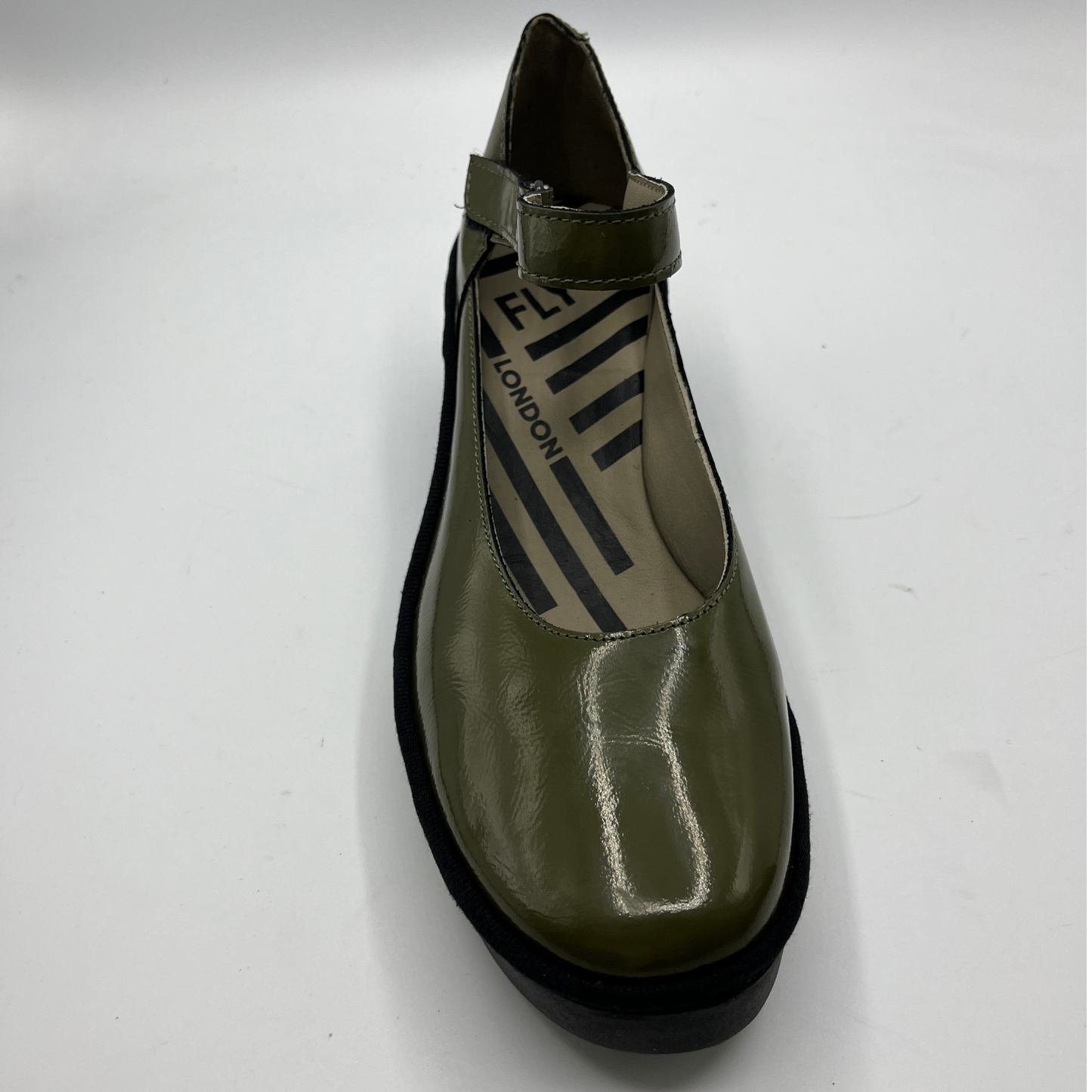 Green shoe with black sole on a white background