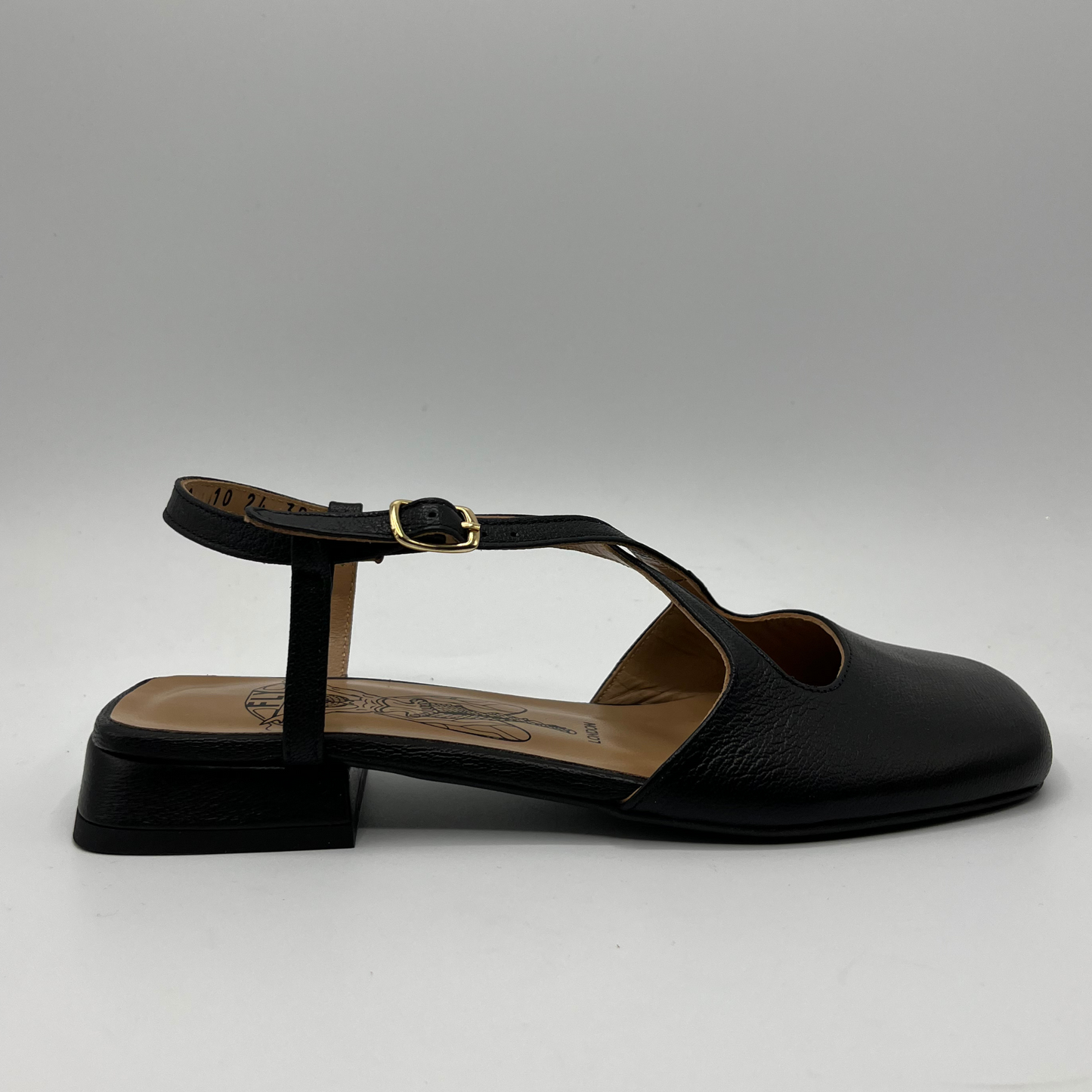 Right facing view of a black leather sandal with a closed toe, an adjustable ankle strap and a low heel.