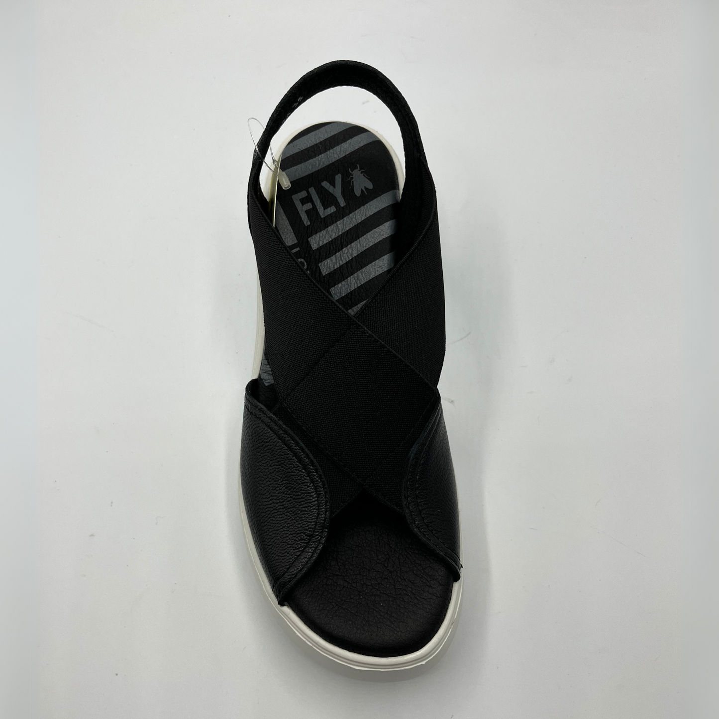 Top view of a black leather and elastic strapped sandal with white rubber wedge outsole