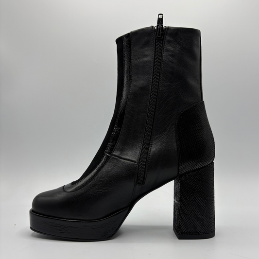 A single black leather ankle boot with a high block heel, platform sole, and side zipper, shown from a side profile on a light gray background.