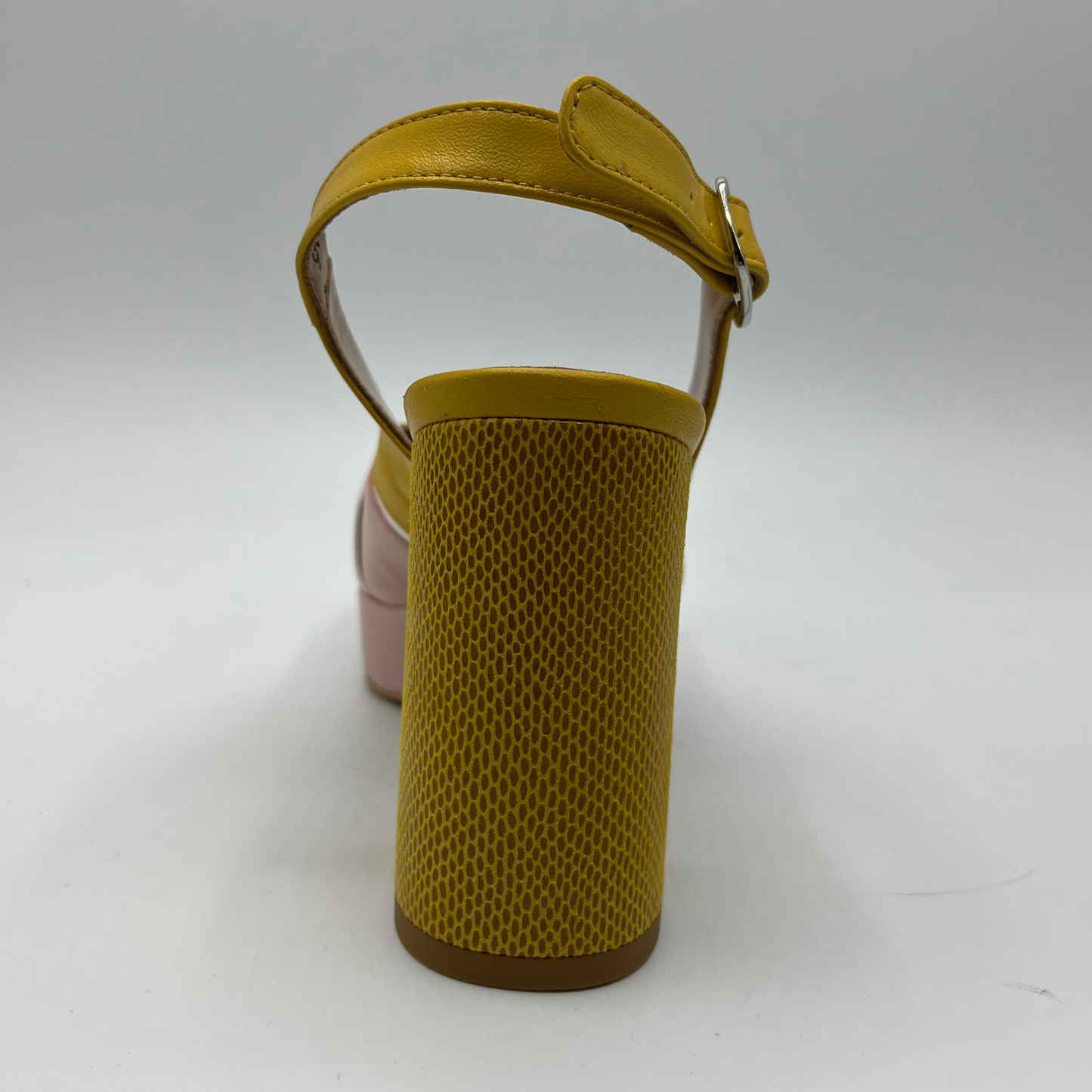 Back view of a yellow and pink high heeled shoe with a white buckle detail and an adjustable slingback strap.